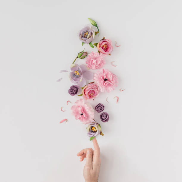 istock Creative layout made with pink and violet flowers on bright background. Flat lay. Spring minimal concept. 910887702