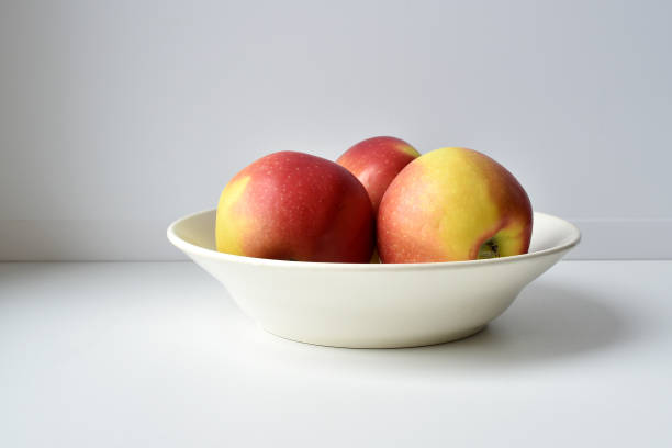istock Apples in the plate on white background 910904438