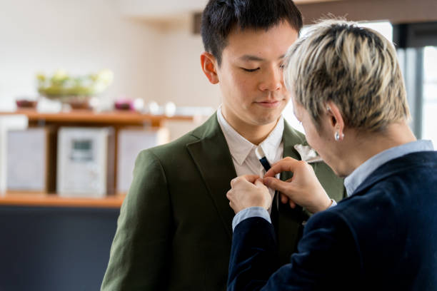 istock Young male couple helping each other to get ready 910906232