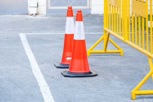 istock traffic warning cone in row to separate route in parking area 910912464