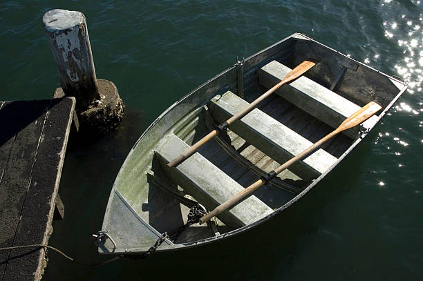Small row boat tied up at a jetty