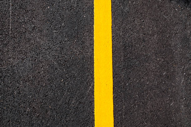 istock Yellow line on new asphalt detail 910924942