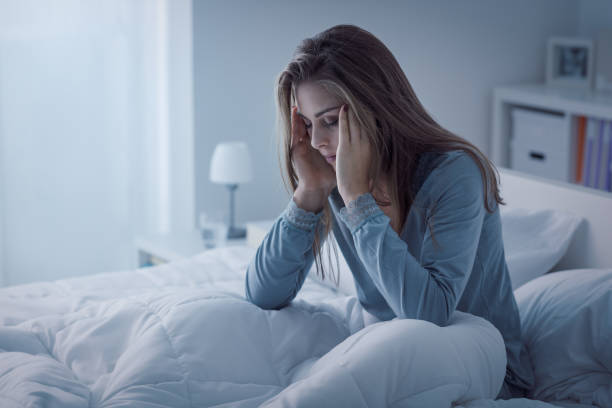 Depressed woman awake in the night Depressed woman awake in the night, she is exhausted and suffering from insomnia trouble sleeping stock pictures, royalty-free photos & images