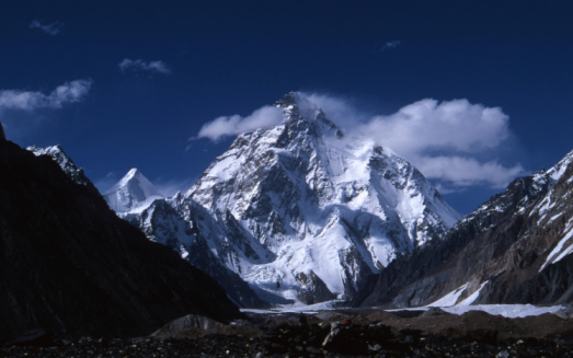 The iconic snow capped spire of Ama Dablam towering over the white washed stupa memorial to Tenzing Norgay on the trail through the dramatic Khumbu valley to Mt. Everest base camp deep in the Himalayas of Nepal. ProPhoto RGB profile for maximum color fidelity and gamut.