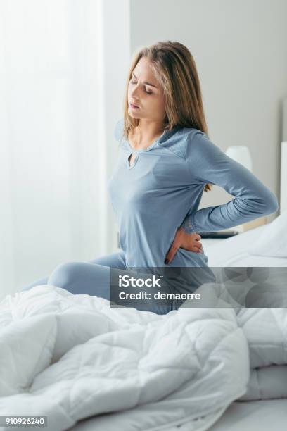 Woman With Back Pain Stock Photo - Download Image Now - Backache, Women, One Woman Only