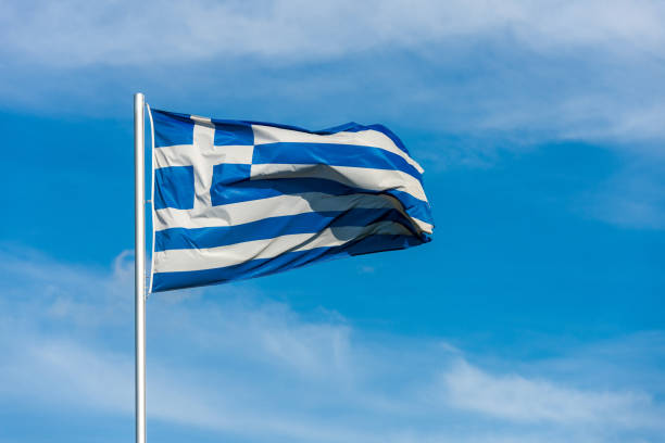 istock French flag waggling in the wind with sky in background 910933472