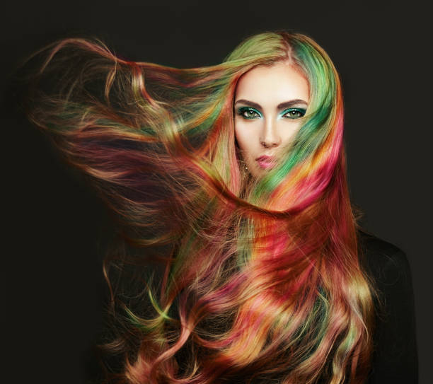 Portrait of young beautiful woman with long flying hair Portrait of young beautiful woman with long flowing hair. Model with perfect Healthy Dyed Hair. Rainbow Hairstyles hair salon photos stock pictures, royalty-free photos & images