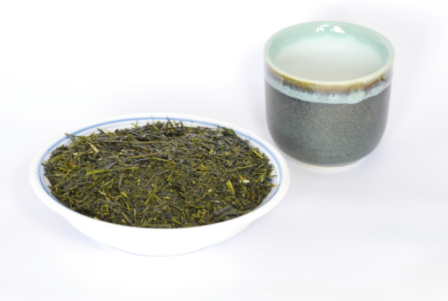 Tea set of green tea leaves and Oriental tea cup
