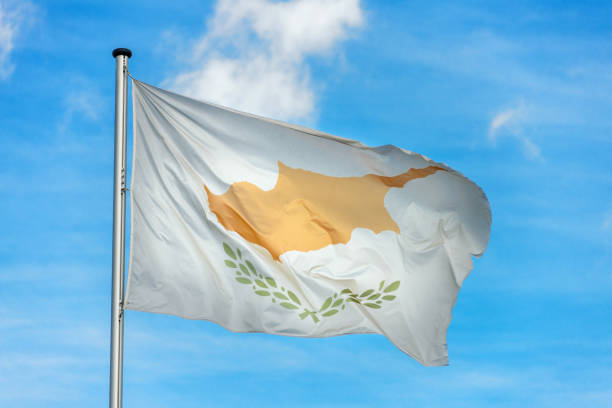 istock Cypriot flag waggling in the wind with sky 910939938