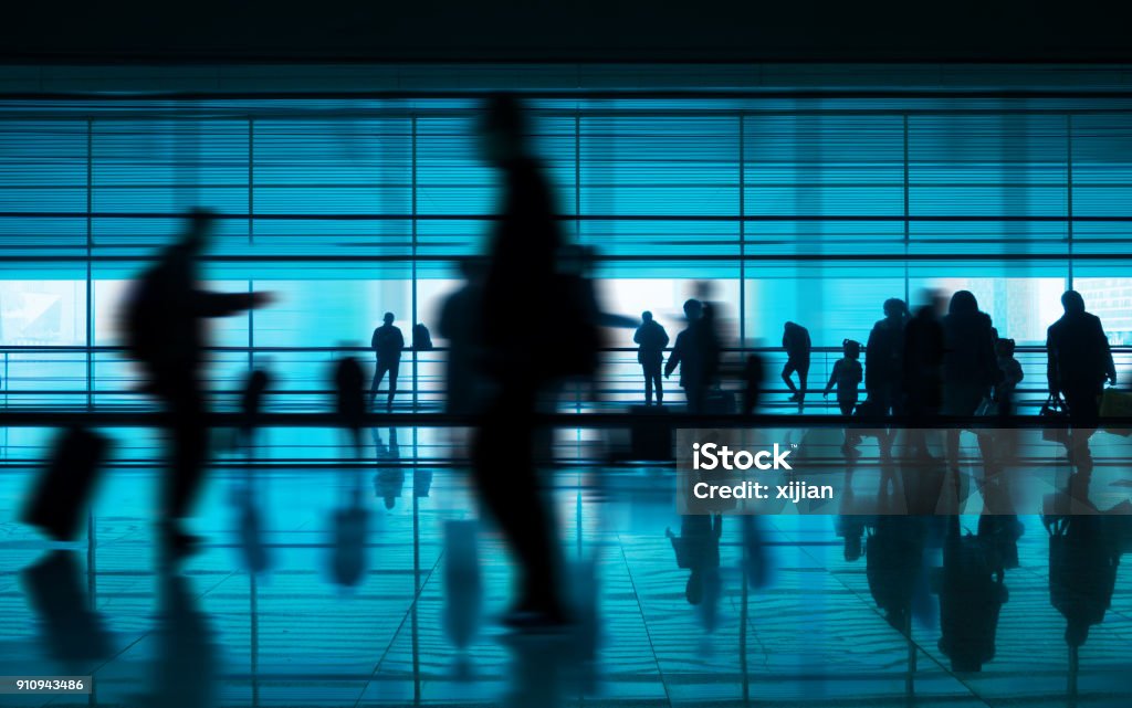 People walking reflection in airport corridor Airport Stock Photo