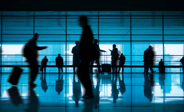 istock travellers walking in modern airport hallway 910943580