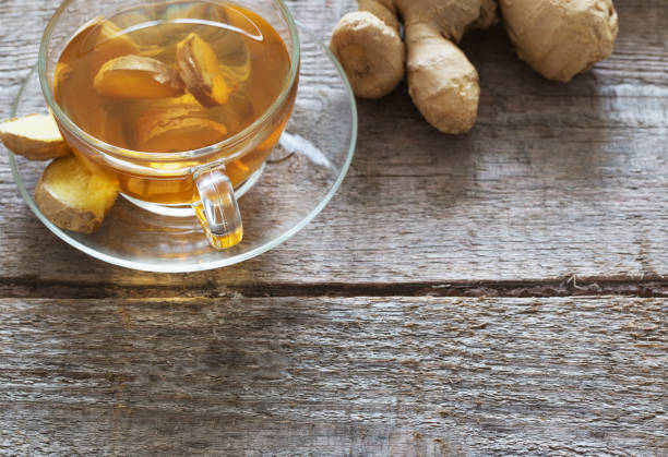 istock Ginger tea and ingredients on a  grunge wooden background 910944980