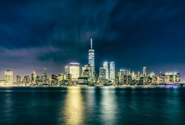 istock new york city manhattan downtown night water reflection crossprocessed 910954572
