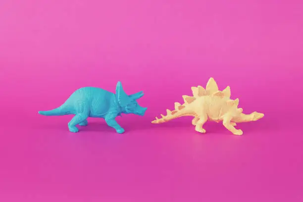 Photo of Colorful Toy Dinosaurs on Pink