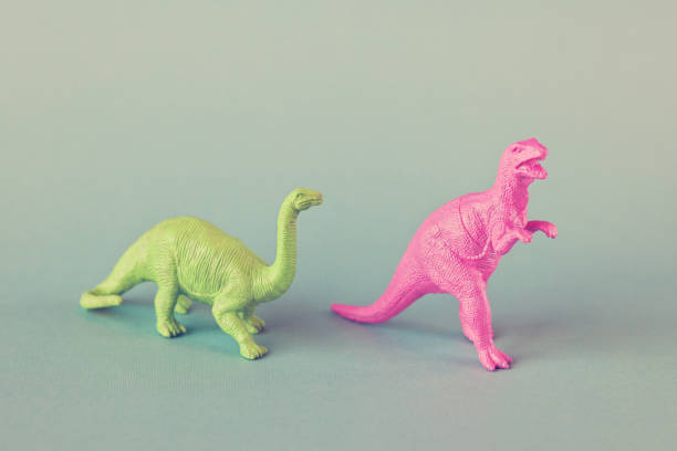 istock Colorful Toy Dinosaurs on Blue Background 910955340