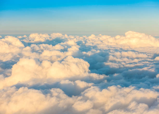 istock Beautiful Sunrise above clouds from airplane window 910958422