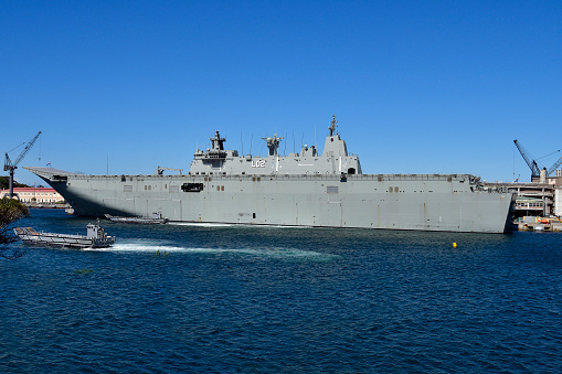Sydney, NSW, Australia - October 31, 2017: HMAS Canberra in Wooloomooloo wharf, a helicopter carrier of the Royal Australian navy and two amphibious Landing Craft ships by exercise