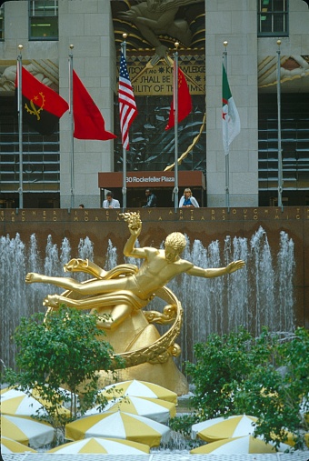 New York City, NYS, USA, 1982. The Rockefeller Center with the golden Prometheus stature in front of the entrance area.
