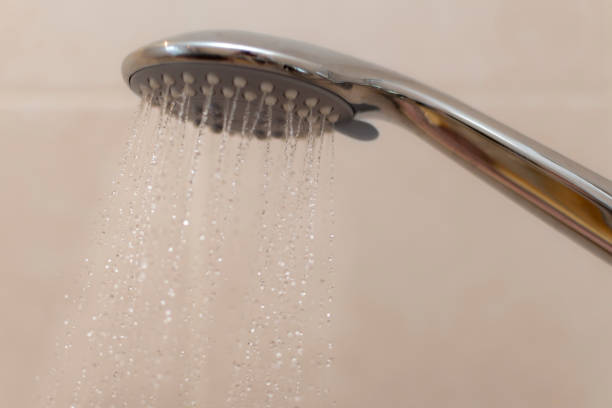 istock Water coming from a chrome shower head, domesic bathroom 910968792