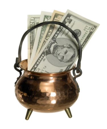copper caldron with dollar banknotes inside, isolated on white with clipping path
