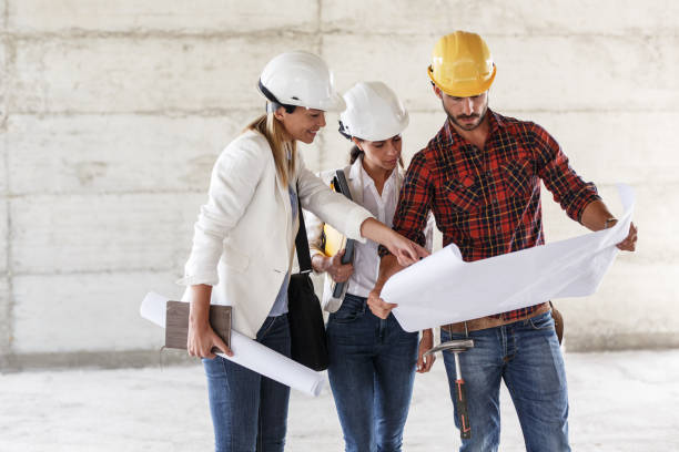 istock Female inspector and architect discuss with head engineer about project. 910974234