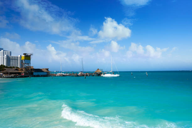 Amazing tropical mexican Caribbean sea and beach landscape panorama view with boat boats yacht yachts ship ships to Cozumel island clear turquoise blue water in Playa del Carmen Quintana Roo Mexico.