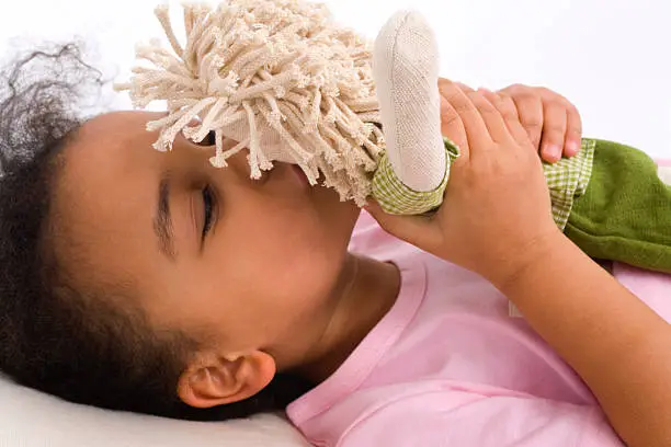 Photo of Mixed Race Interracial African American Girl Kissing Her Doll