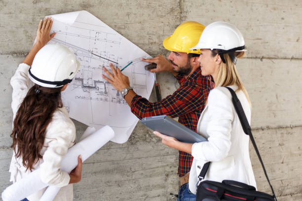 istock Team of inspectors and architects discuss about blueprints 910974860