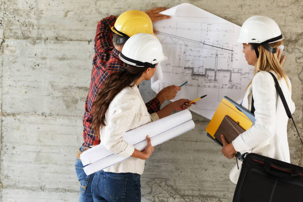 istock Team of inspectors and architects discuss about blueprints 910975414