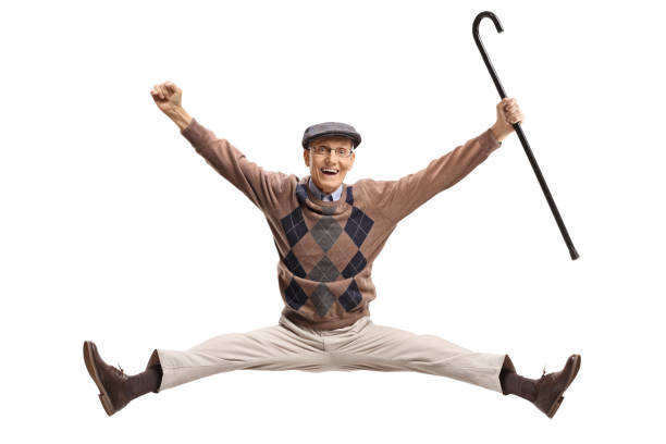 Overjoyed senior with a cane jumping isolated on white background