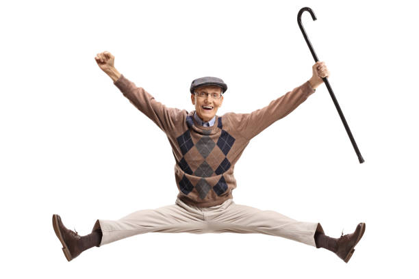 Overjoyed senior with a cane jumping Overjoyed senior with a cane jumping isolated on white background one senior man only stock pictures, royalty-free photos & images
