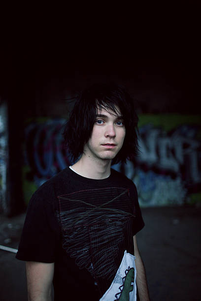 istock Dark Haired Boy Standing in front of Graffiti Covered Wall 91098267
