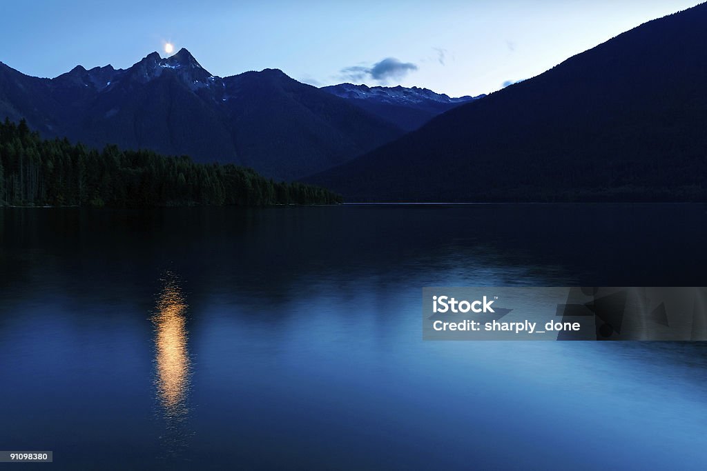 twilight mountain lake mountain lake at twilight with reflecting moonlight Night Stock Photo