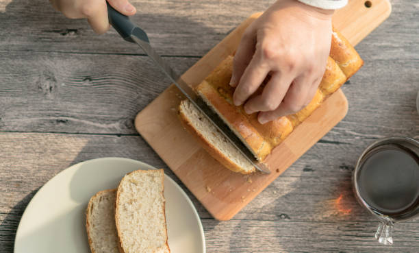 istock cutting fresh homemade loaf bread into slices 910983860