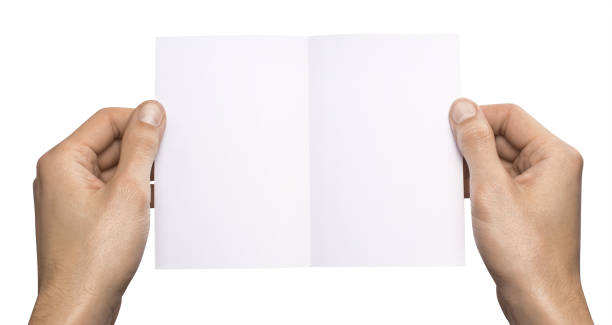 istock Empty white A6 postcard horizontally. Man holding a template isolated in his hands 910984622