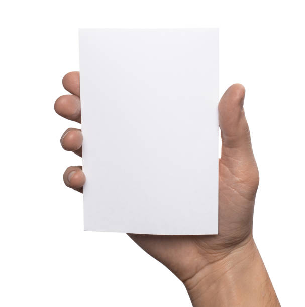 istock Empty white A6 postcard vertically. Man holding a template isolated in his hand 910984642