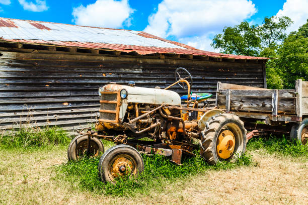 istock Old Tractor by Wood Barn 910987448