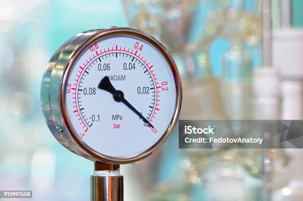 Pressure Gauge On A Blurry Industrial Background Stock Photo - Download Image Now - Accuracy, Arrow Symbol, Atmosphere