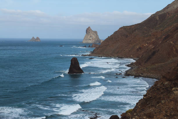 istock Remote beaches on coastline next to the mountains with crashing waves in ocean 910994830