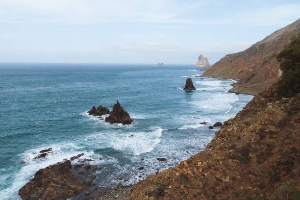 istock Remote beaches on coastline next to the mountains with crashing waves in ocean 910994840