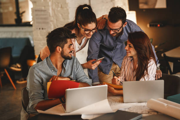 istock Group of casual business people working on new project 910995650