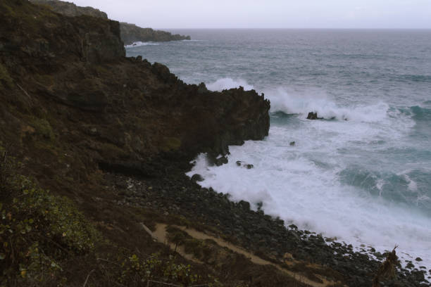 istock Breaking waves on coastline in dark cloudy  weather 910995898
