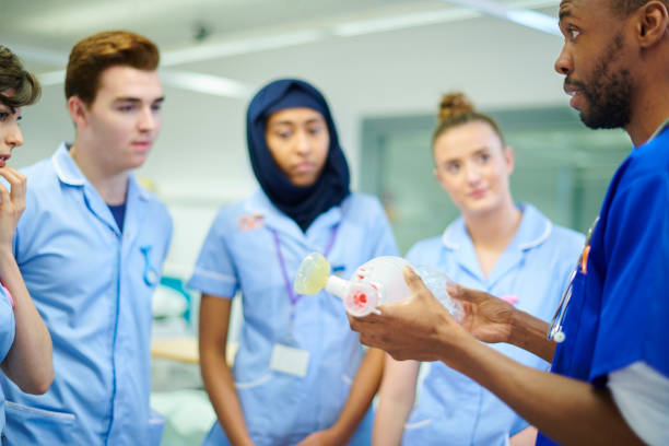 istock anaesthetist demonstrating apparatus to students 910999286