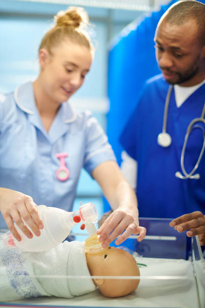 istock medical student with baby simulator and paediatric nurse 910999596
