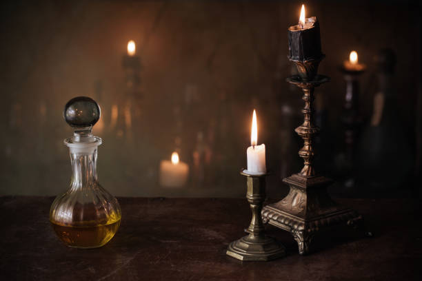 istock Magic potion, ancient books and candles on dark background 911000278