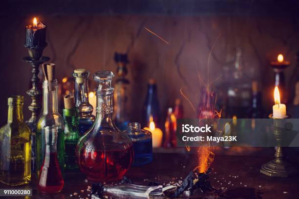 Magic Potion Ancient Books And Candles On Dark Background Stock Photo - Download Image Now