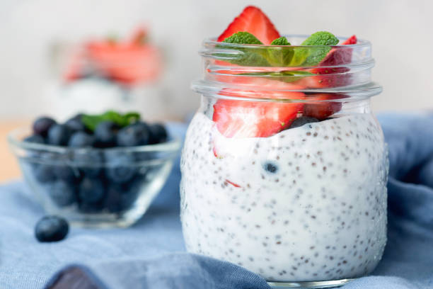 Chia pudding in jar with strawberries, blueberries and mint Chia pudding in jar with strawberries, blueberries and mint. Closeup view parfait photos stock pictures, royalty-free photos & images