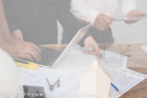 istock Architect working on real estate project with partner at workplace. engineer discussing with colleague on house blueprint at office. Business, people, construction and building concept 911011866