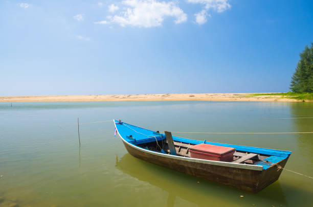 istock Boat at beach and blue sky 911011912