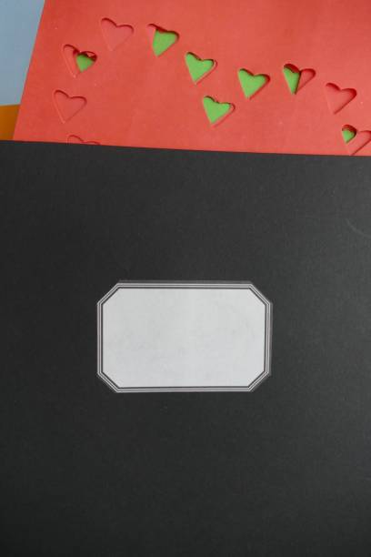 Black notebook title and abstract red hearts above